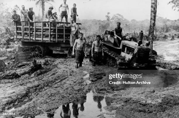 Marines force their way through the sea of mud with a bulldozer to deliver supplies for the troops on Bougainville Island.