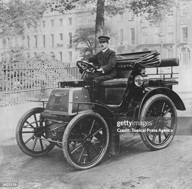 Chauffeur sitting at the wheel of the first car of King Edward VII, a 6-horsepower Daimler.