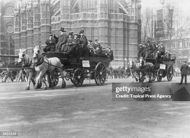 Football supporters on horse-drawn buses visiting London for the FA Cup Final between Barnsley and West Bromwich Albion.