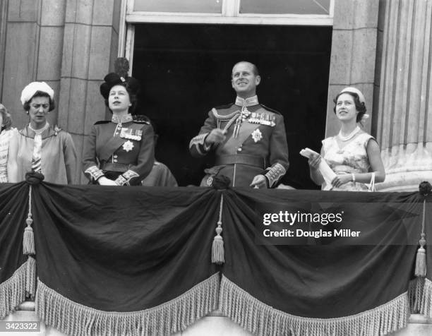 To r, the Duchess of Kent , Queen Elizabeth II, Prince Philip and Princess Margaret watching an RAF fly past from Buckingham Palace balcony after the...