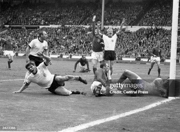 West Germany's Wolfgang Weber starts to celebrate after scoring past England's goalkeeper Gordon Banks, for an equaliser in the last minute of normal...