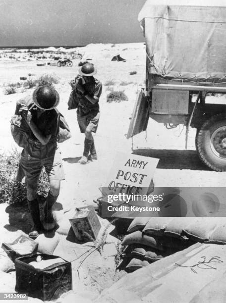 Officers from the Army Postal Service delivering post at a station in the Western Desert, North Africa.