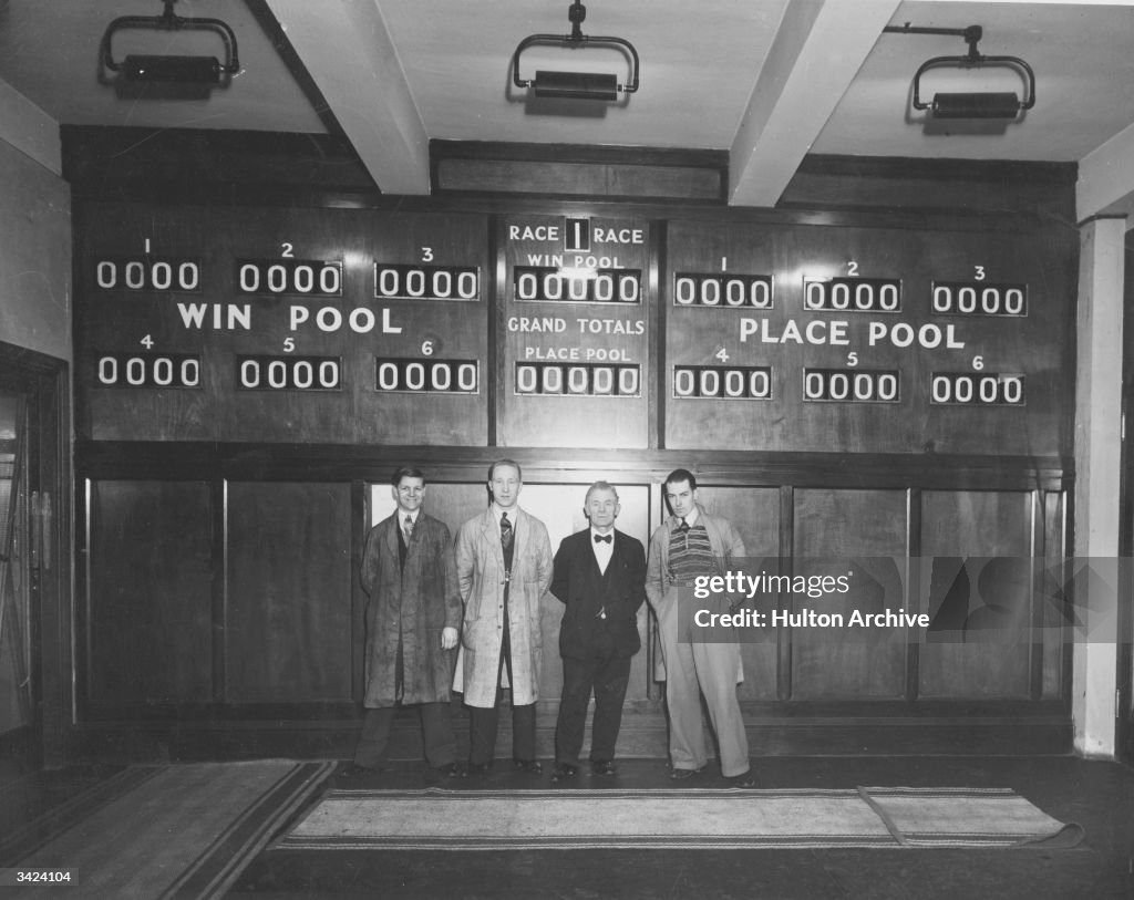 Totalisator Four men standing in front of a totalisator, or tote machine. News ...