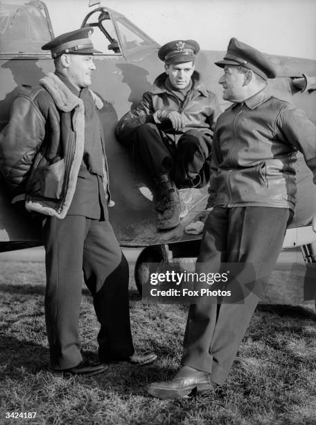 Lieutenant W J Stangel, Captain Thomas Wallace and American film director Major William Wyler , all of the US Army Air Corps, discuss tactics. Wyler...