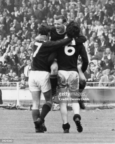 Bobby Lennox is congratulated by team mates Willie Wallace and Jim Baxter after scoring Scotland's second goal against England at Wembley. Scotland...