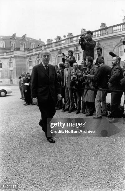 Edouard Balladur, Minister of Economics, Finance, and Privatisation, arrives at the Elysee Palace, under the watchful eyes of the Press.