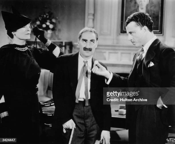 Margaret Dumont as Emily Upjohn and Groucho Marx as Doctor Hugo Z Hackenbush in the film 'A Day at the Races', directed by Sam Wood and produced by...