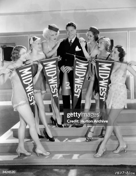 Toby Wing , Hollywood's prettiest chorus girl is standing to the immediate left of Jack Oakie , real name Lewis Delaney Offield, the American comic...