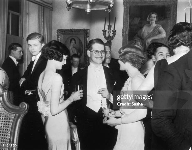 Guests chatting over cocktails, at the Noble Arts Ball.
