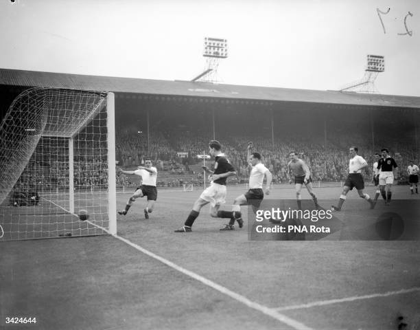 Devine of Queen's Park Rangers scoring Scotland's first goal in the Amateur International at Wembley.