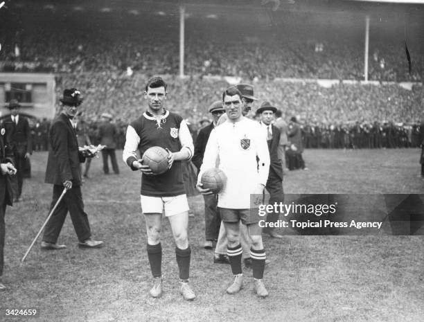 Kay, captain of West Ham United, and Joe Smith, captain of Bolton Wanderers, on the pitch before the start of the FA Cup Final at Wembley Stadium,...