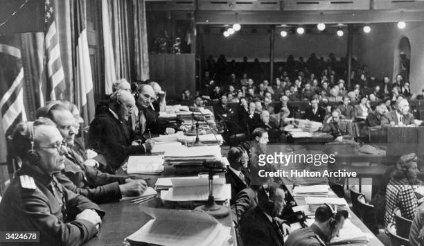 Members of the Tribunal , preside over the Nuremberg war crimes Trials. From left to right are : Colonel A F Volchlov , General J T Nikitchenko ,...