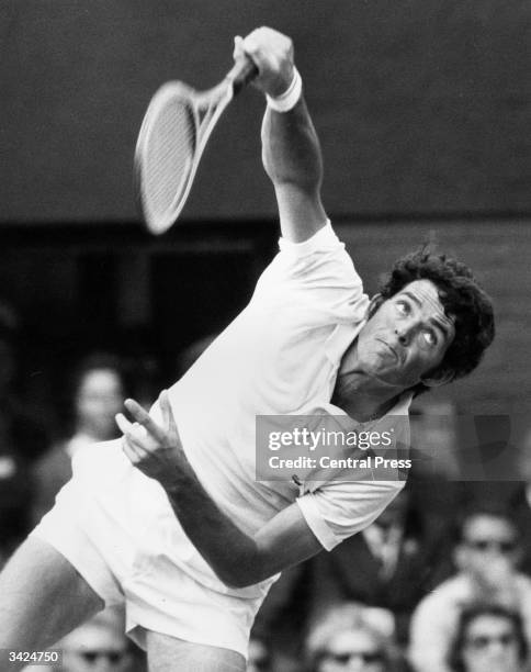 Tom Gorman of the USA in action serving against Australia's Rod Laver during their quarter final match at the Wimbledon Lawn Tennis Championships....