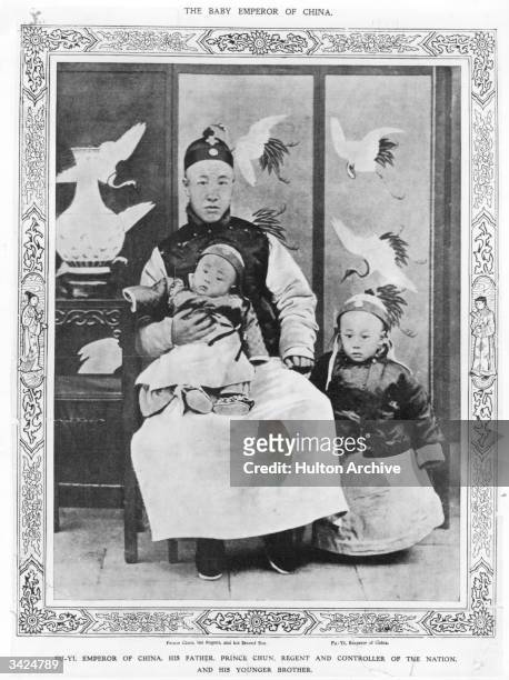 Prince Chun, Regent and controller of the Nation, with his younger son on his knee and Pu-Yi Emperor of China, by his side.