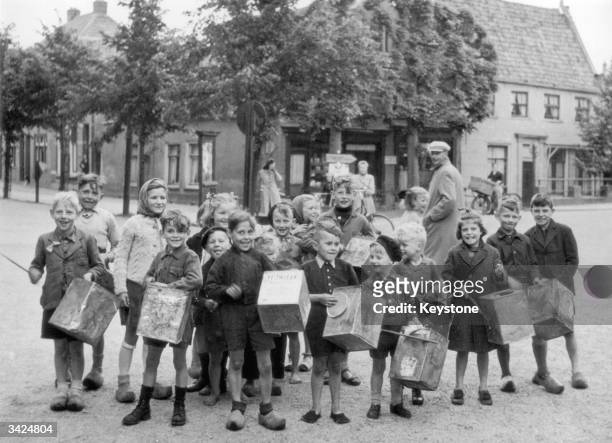 Dutch youngsters who have enjoyed free food supplied by the Allied forces beat empty biscuit tins on full stomachs in Amsterdam.