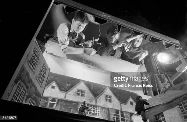 Boys from the puppet club get to grips with their marionets, at Stowe Public School, Buckinghamshire. Original Publication: Picture Post - 4275 - A...