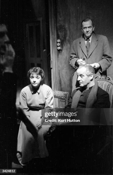 Writer Grahame Greene lurks in the background while Dorothy Tutin and Eric Portman rehearse a scene from his play 'The Living Room'. Original...