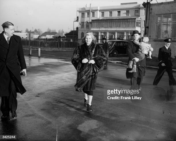 American actress Rita Hayworth leaving Croydon airport in London with her daughter Rebecca.