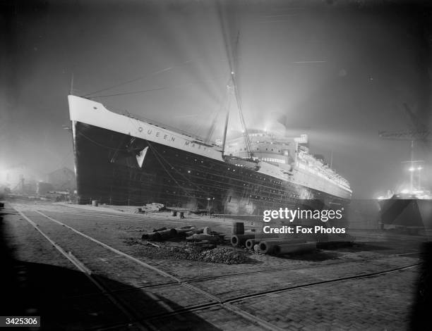 The newly completed SS Queen Mary, flloodlit at night, at the shipyard on Clydebank, Scotland.