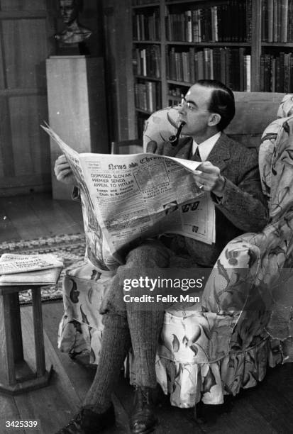 Labour politician Sir Stafford Cripps reading a newspaper at his home in the Cotswolds. Original Publication: Picture Post - 178 - At Home: Sir...