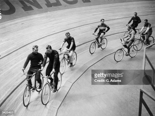 Competitors taking it easy for a spell during the Six Days International Cycle Race at Wembley, London.