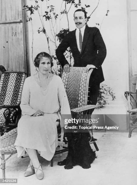 King Alfonso XIII and his Queen sit with their dog. He was the last Spanish king, rejected by the public in a referendum in 1931. He refused to...
