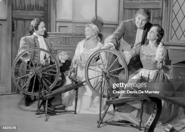 At their spinning wheels in a scene from Flotow's opera, 'Martha'. Cast includes June Bronhill as Lady Harriet, Anna Pollack as Nancy, Frederick...