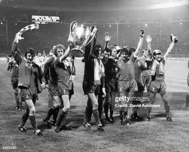 The players of Liverpool Football Club carry the trophy on a lap of honour after their 1-0 victory over FC Bruges in the European Cup final at...