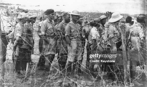 British prisoners-of-war taken at Tobruk and Mersa Matruk are being transferred from a desert camp to a prison camp in Italy.