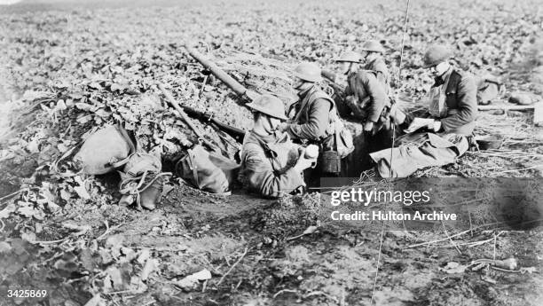 Irish Guardsmen stand at their post five minutes before the Armistice, near Maubeuge on 11th November 1918.