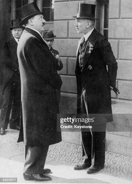 Chancellor Adolf Hitler in conversation with Franz Von Papen , the former Chancellor.