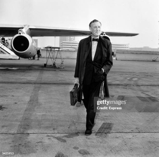 Ian Fleming , author of the James Bond novels, at an airfield.