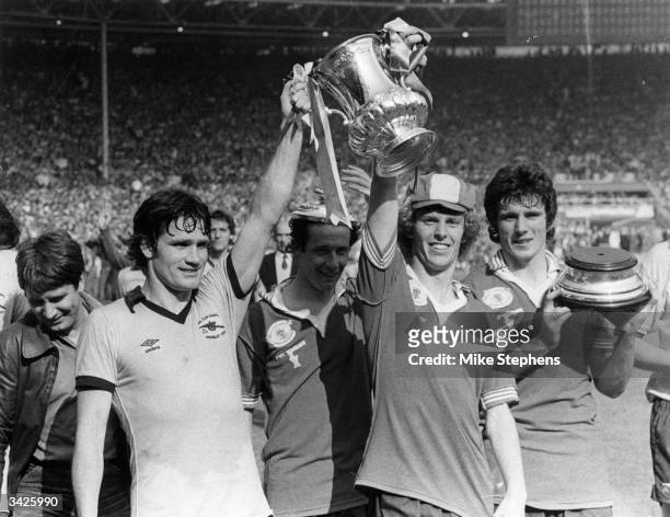 Arsenal players Pat Rice , Liam Brady, Graham Rix and Frank Stapleton with the FA Cup after beating Manchester United 3-2 at Wembley Stadium, London.