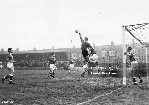 Plymouth Argyle goalkeeper, Barnsley, punches the ball clear from a Gillingham corner kick at Gillingham, in a first round FA Cup replay.