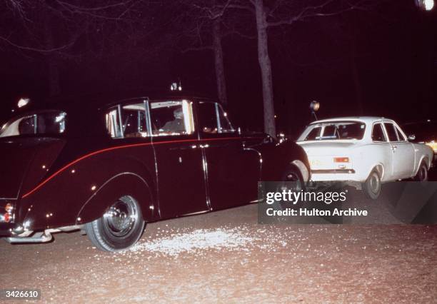 The aftermath of Ian Ball's attempt to kidnap Princess Anne, on The Mall, London, 20th March 1974. Ball's white Ford Escort is parked blocking the...
