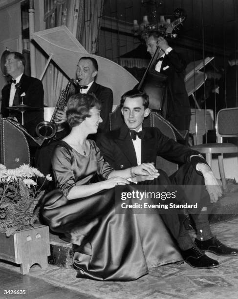 Pamela Breadnam and Sub Lieutenant Richard Brown resting during a dance in Dorchester while the band plays behind them.