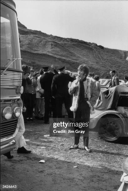 Liverpudlian popstar John Lennon takes a break from the filming of The Beatles' latest film 'The Magical Mystery Tour', at Newquay, Cornwall.