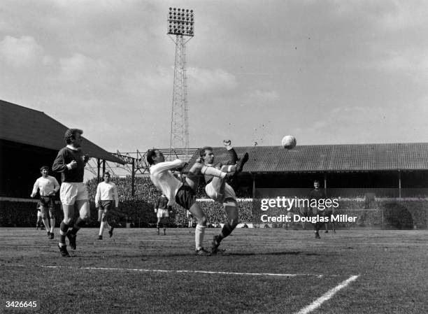 Alan Gilzean of Spurs fights for the ball with Jackie Charlton during a match between Tottenham Hotspur and Leeds at White Hart Lane.