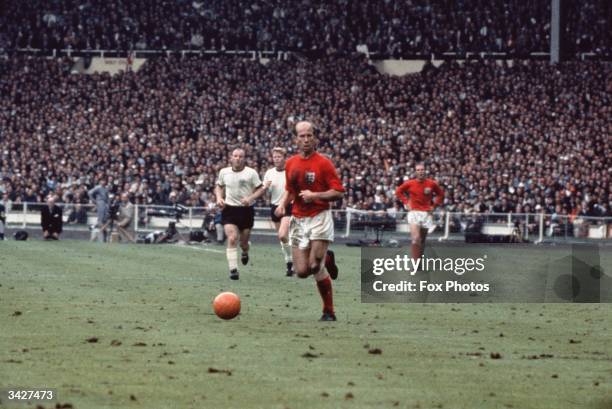 Bobby Charlton with the ball during the 1966 World Cup Final against West Germany at Wembley Stadium. England won 4-2.