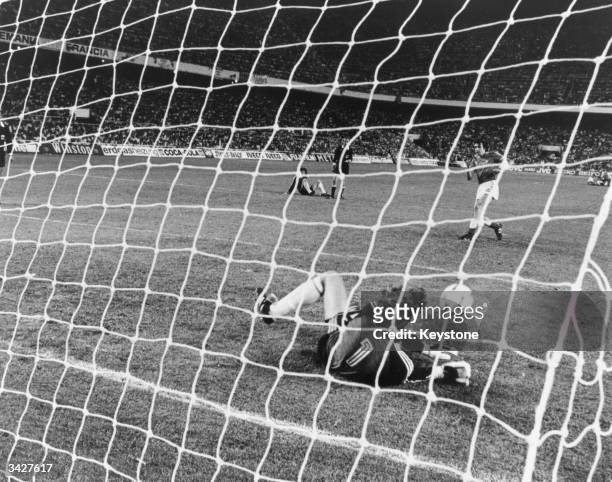 German goalkeeper Schumacher saves Bossis' shot at the goal in the penalty shoot-out after the World Cup semi-final match between West Germany and...