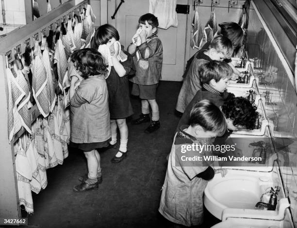 Children in the washroom at the LCC Columbia Nursery School in Bethnal Green, London.