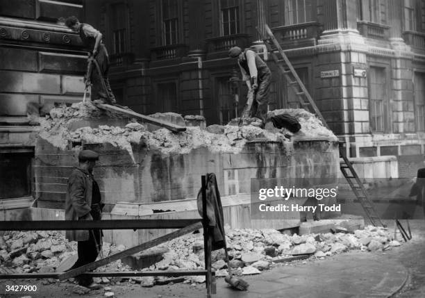 One of the last concrete pillboxes outside Downing Street in Whitehall, London, is demolished.