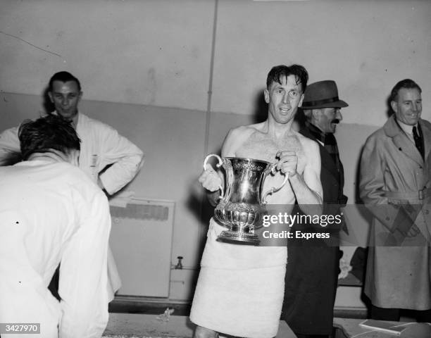 Arsenal's Joe Mercer holding the FA cup after his team's win against Liverpool in the cup final at Wembley. The final score was 2:0.