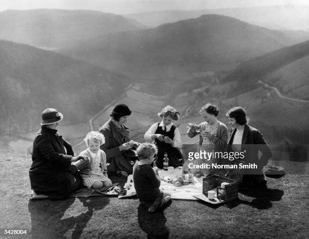 Family picnic party enjoying a sunny day on the Horseshoe Pass, North Wales.