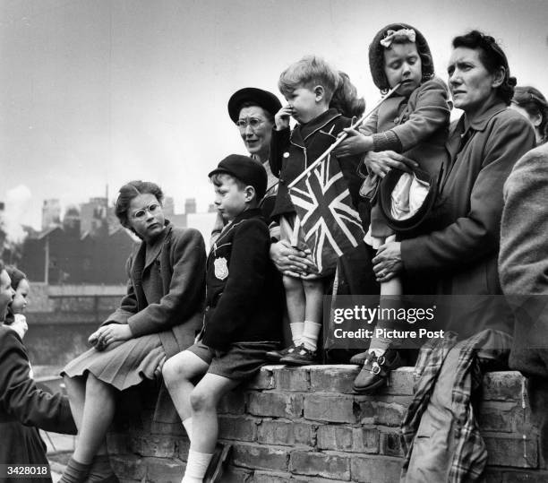 Families watching the Royal procession as King George VI goes to St Paul's to declare the Festival of Britain open. Original Publication: Picture...