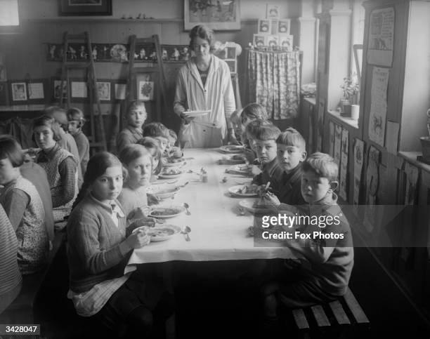 Schoolchildren at the dinner table in Boxgrove near Goodwood, Sussex.