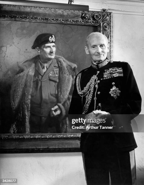 At his home, Islington Mill, Alton, Hampshire, Field Marshall Viscount Montgomery of Alamein with a portrait of himself painted by Frank Salisbury.
