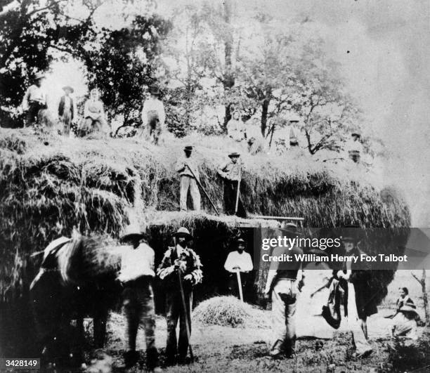 Group of British farm workers resting their pitchforks at haymaking time. Original Artwork: Calotype