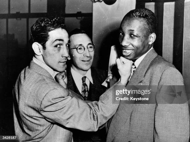 Italian-born US featherweight boxer Willie Pep with Harry Markson of the 20th Century Sporting Club and the World Featherweight Champion Joseph...
