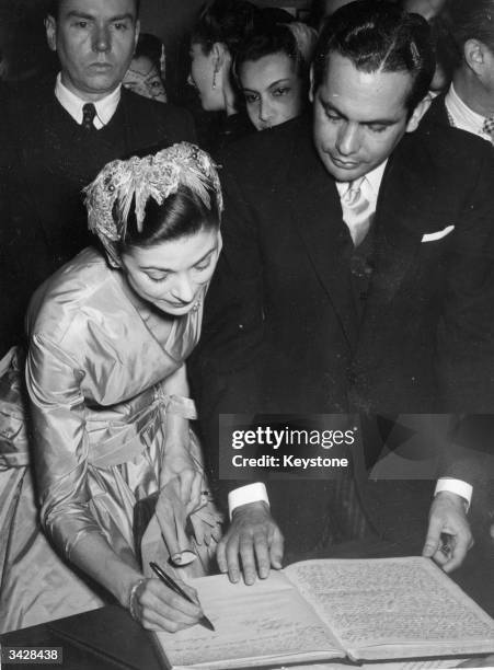 Prima ballerina Dame Margot Fonteyn signs her wedding contract with Panamanian lawyer Dr Roberto Arias at the Panamanian Embassy, Paris.